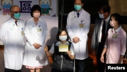 台湾总统蔡英文在台湾大学医院接种台湾自制的疫苗后出示自己的接种记录证明。（2021年8月23日）