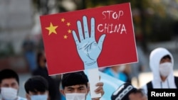 FILE - Ethnic Uighur demonstrators take part in a protest against China, in Istanbul, Turkey, Oct. 1, 2020. 