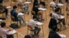 FILE - Students sit for the Diploma of Secondary Education (DSE) exams April 26, 2021, in Hong Kong.