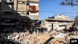 Orang-orang memeriksa bangunan yang terkena pengeboman Israel di Rafah di Jalur Gaza selatan pada 8 Mei 2024. (Foto: AFP)