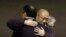 FILE - Kenneth Bae, center, who had been held in North Korea since 2012, is hugged after arriving at Joint Base Lewis-McChord, Washington, Nov. 8, 2014.