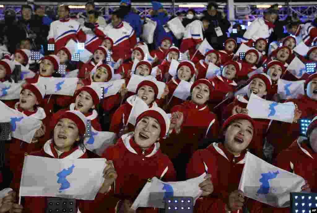 Members of the North Korean delegation hold flags of the combined Koreas before the opening ceremony of the 2018 Winter Olympics in Pyeongchang, South Korea, Feb. 9, 2018.
