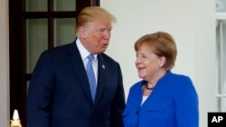 President Donald Trump greets German Chancellor Angela Merkel, April 27, 2018, at the White House in Washington.