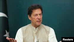 FILE - Pakistan's Prime Minister Imran Khan gestures during an interview with Reuters in Islamabad, June 4, 2021.