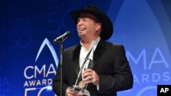 Garth Brooks, winner of the award for entertainer of the year, participates in an interview in the press room at the 50th annual CMA Awards at the Bridgestone Arena in Nashville, Tennessee, Nov. 2, 2016.