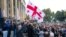 Supporters of the ex-President Mikhail Saakashvili's United National Movement, wave Georgian national flags during rally to protest the election results rally in front of the parliament's building in Tbilisi, Georgia, Nov. 1, 2020.