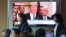 People pass by a TV screen showing a footage of U.S. President Donald Trump during a news program at the Seoul Railway Station in Seoul, South Korea, May 25, 2018. 