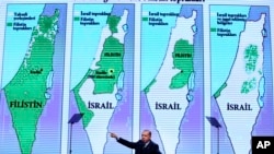 Backdropped by maps of Israel and the Palestinian Territories, Turkey's President Recep Tayyip Erdogan, gestures as talks at the closing ceremony of exporters' innovation and entrepreneurship week event, in Istanbul, Saturday, Dec. 9, 2017. Erdogan has called on Muslims to act within the scope of law and democracy and remain calm in their response to the U.S. President Donald Trump's recognition of Jerusalem as the capital of Israel.