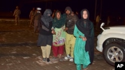 Passengers rescued by security forces from a passenger train attacked by insurgents arrive at a railway station in Quetta, Pakistan, March 12, 2025. 