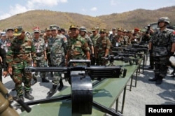 Major General Zhang Jian, commander of the Chinese People's Liberation Army Southern Theatre Command, and Pol Saroeun, commander-in-chief of the Cambodian military, attend the opening of military exercise in Kampong Speu province, Cambodia, March 17, 2018.