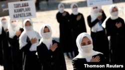 Ethnic Uighur women take part in a protest against China, in Istanbul