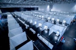 A makeshift clinic for the treatment of people infected with the coronavirus is set up on exhibition grounds in Hannover, Germany, April 4, 2020.