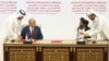 FILE - In this Feb. 29, 2020, photo, U.S. peace envoy Zalmay Khalilzad, left, and Mullah Abdul Ghani Baradar, the Taliban's top political leader, sign a peace agreement between Taliban and U.S. officials in Doha, Qatar. 