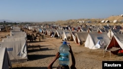 People displaced because of the floods take refuge in a camp, in Sehwan, Pakistan