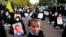 Iranian protesters hold defaced pictures of French President Emmanuel Macron during a protest against the publishing of caricatures of the Prophet Muhammad they deem blasphemous, in front of French Embassy in Tehran, Oct. 28, 2020. (AP/Ebrahim Noroozi)
