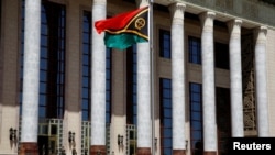 FILE - A Vanuatu flag flutters outside the Great Hall of the People in Beijing, May 27, 2019. The prime ministers of the Solomon Islands and Vanuatu are visiting China this week.