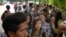 FILE - Myanmar citizens wait for their turn outside the Myanmar Embassy in Singapore to cast advance ballots in the country's Nov. 8 general election, Oct. 18, 2015. 