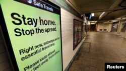 A message is seen on an electronic display inside a mostly empty 42nd Street subway station during the coronavirus outbreak in New York City, March 20, 2020. 