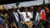 Opposition leader Raila Odinga holds a bible aloft after swearing an oath during a mock "swearing-in" ceremony at Uhuru Park in downtown Nairobi, Kenya, Jan. 30, 2018. 