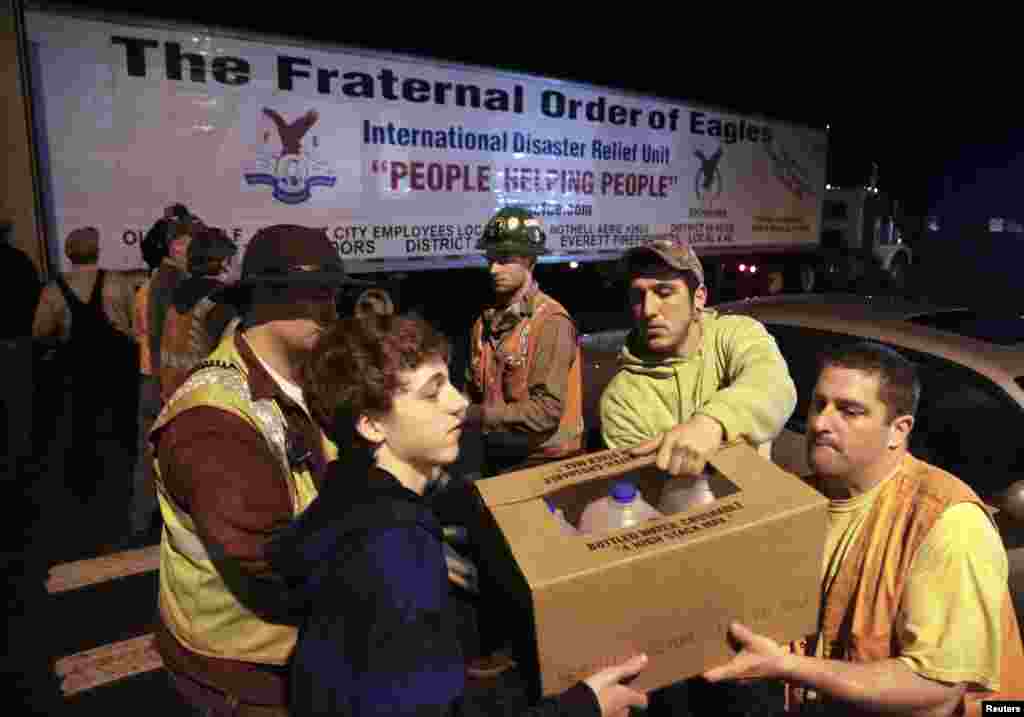 Community members unpack a truckload of donated goods from The Rock Church, Darrington, Washington, March 26, 2014.