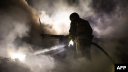 This handout photograph taken and released by the Ukrainian Emergency Service on November 11, 2024, shows a rescuer working at the site of a Russian night strike in Mykolaiv, amid the Russian invasion of Ukraine.