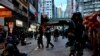 FILE - Riot police tell journalists to leave while they arrest protesters in Hong Kong, Oct. 6, 2019. 
