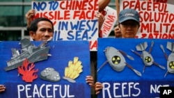 Environmental activists picket the Chinese Consulate to protest alleged military buildup by China on the disputed group of islands at the South China Sea, in Manila, Philippines, Jan. 24, 2017. The Philippines is one of the nations that disputes China's claim to the entire sea. 