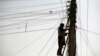 FILE - An Afghan man repairs electricity cables along the streets of Kabul, Nov. 16, 2009. The country is negotiating for an increase in energy supplies from its Central Asian neighbors.