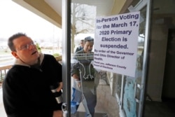 FILE - Jefferson County Elections officials arrive to pack up the polling place at Our Lady of Lourdes church in Wintersville, Ohio, March 17, 2020.