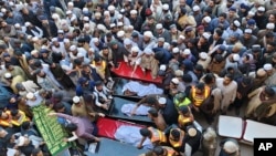 People attend the funeral prayers for the victims of the previous day's suicide bombing in Bannu, northwestern Pakistan, March 5, 2025. 