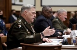 From left, Gen. Mark Milley, chairman of the Joint Chiefs of Staff, Secretary of Defense Lloyd Austin and Marine Corps Gen. Kenneth McKenzie, commander of U.S. Central Command, testify during a House Armed Services Committee hearing on Capitol Hill in Washington, Sept. 29, 2021.
