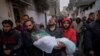 FILE - Mohammad Shouman carries the body of his daughter, Masa, who was killed in an Israeli bombardment of the Gaza Strip, during her funeral in Rafah, southern Gaza, Jan. 17, 2024. 