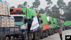FILE - South Korean trucks with food aid prepare to leave for North Korean city of Kaesong in Paju, South Korea, Sept. 21, 2012. 