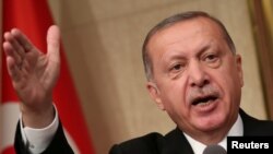 Turkish President Tayyip Erdogan makes a speech at the Presidential Palace in Ankara, July 15, 2018.