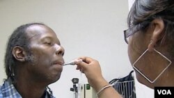 FILE - A patient receives treatment at the Arlington Free Clinic in Arlington, Virginia.