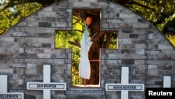 FILE - The memorial "Tulipanes de Esperanza," built as a homage to journalists Koos Koster, Jan Kuiper, Joop Willemsen and Hans ter Laag, near the place where they were killed, is seen in Santa Rita, El Salvador, Oct. 24, 2024.