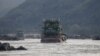 FILE - Chinese cargo ships sail on the Mekong river near the Golden Triangle at the border between Laos, Myanmar and Thailand March 1, 2016.