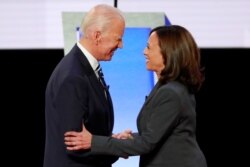 Former Vice President Joe Biden and Senator Kamala Harris shake hands before the start of the second night of the second 2020 presidential Democratic candidates debate in Detroit, July 31, 2019.