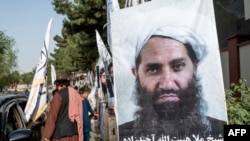 FILE - A poster of Taliban supreme leader Hibatullah Akhundzada is seen along a road in Kabul, Afghanistan, on Aug. 14, 2023. 