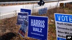 Campaign signs for Republican presidential nominee former President Donald Trump and Democratic presidential nominee Vice President Kamala Harris, line a highway, Oct. 31, 2024, in Barrington, N.H.