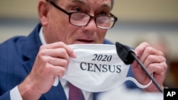 FILE - U.S. Census Bureau Director Steven Dillingham holds up his mask with the words "2020 Census" as he testifies before a House Committee on Oversight and Reform hearing on the 2020 Census​ on Capitol Hill, July 29, 2020, in Washington.