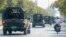 FILE - A convoy of army vehicles patrol the streets in Mandalay, Myanmar, Wednesday, Feb. 3, 2021.