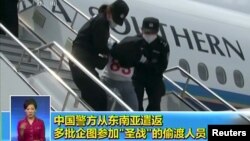 People being deported from Thailand are seen brought off an airplane by police at an unidentified location in China on July 9, 2015 in this still image taken from CCTV video aired on July 11, 2015. 