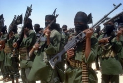 FILE - Islamist fighters loyal to Somalia’s al-Qaida-inspired al-Shabab group perform military drills at a village in Lower Shabelle region, some 25 kilometers outside Mogadishu, Feb. 17, 2011.