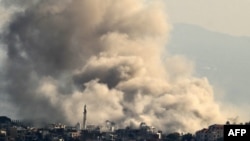 Thick smoke rises from explosions as Israeli forces reportedly demolish dwellings in the border town of Khiam in southern Lebanon, on Dec. 1, 2024, days into a fragile ceasefire between Israel and Hezbollah.