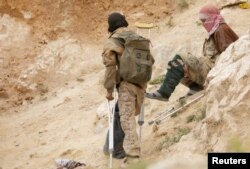Injured Islamic state militants are seen in the village of Baghouz, Deir Al Zor province, Syria, March 14, 2019.