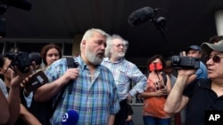 FILE - Dmitry Muratov, foreground, chief editor of Novaya Gazeta, and the Ekho Moskvy (Echo of Moscow) radio station's editor-in-chief, Alexei Venediktov, speak in Moscow, Russia, in June 2019.