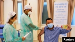 A man receives a vaccine as Cambodia starts its coronavirus disease (COVID-19) vaccine rollout with 600,000 doses of Sinopharm vaccine donated by China in Phnom Penh, Cambodia, February 10, 2021. (REUTERS/Cindy Liu)