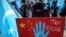 A protester from the Uyghur community living in Turkey holds up an anti-China placard during a protest against the visit of China's Foreign Minister Wang Yi to Turkey, in Istanbul, March 25, 2021.