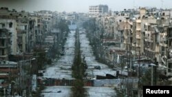 A general view shows a damaged street with sandbags used as barriers in Aleppo's Saif al-Dawla district, Syria, March 6, 2015. The U.S. and Russia say their combined effort to quell unrest in Syria has resulted in a significant decrease in fighting in some areas.